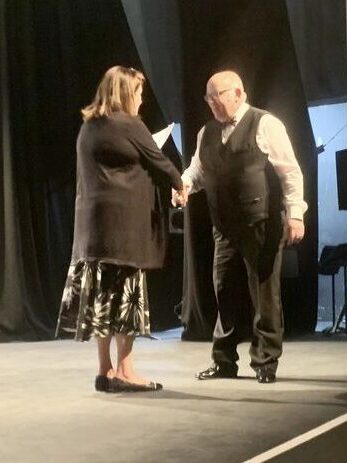 Winslow Concert Band MD Paul How being awarded with the Bronze medal at the MK Music Festival 2023