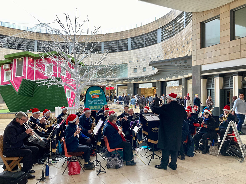 Winslow Concert Band playing Christmas music in Midsummer Place and raising money for the First Responders of the South Central Ambulance Service